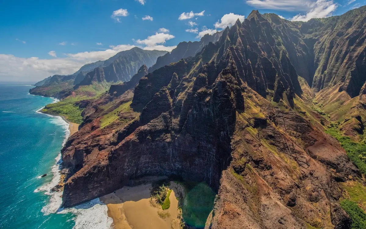 Green cliffs of the Na Pali Coast seen from the window of a small aircraft